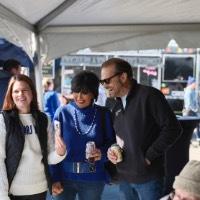 Woman showing President Mantella and man her phone